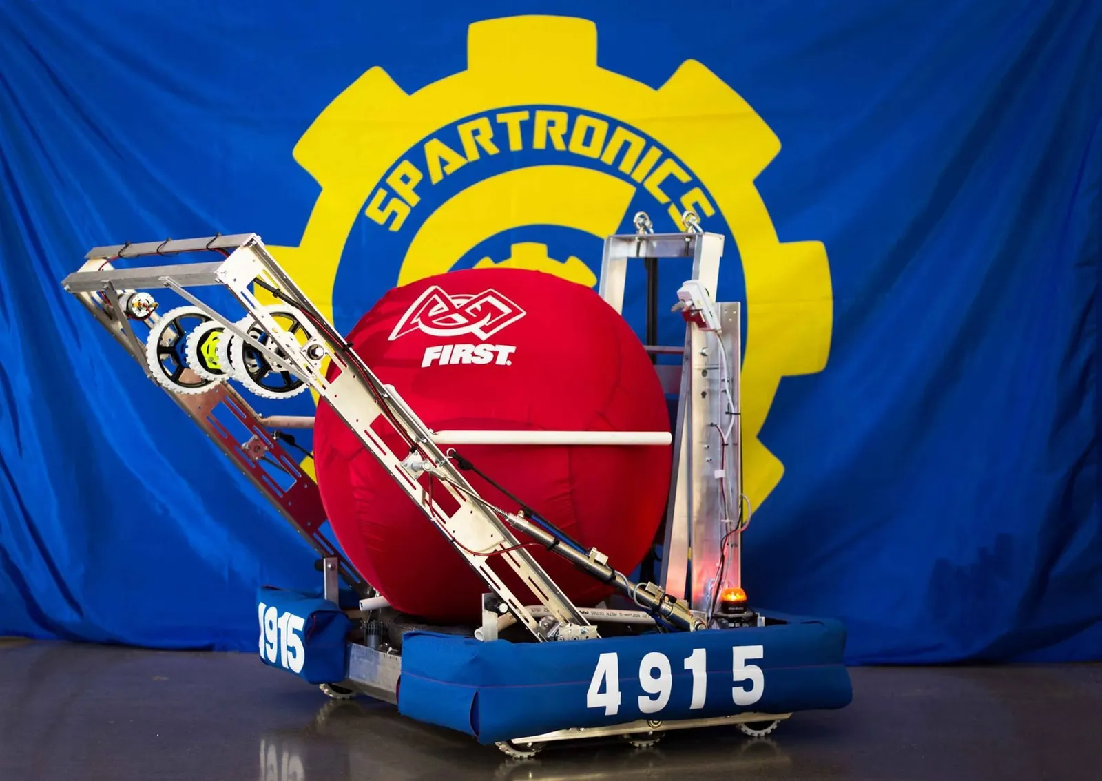 ATLaS, the 2014 robot, in front of the Spartronics banner