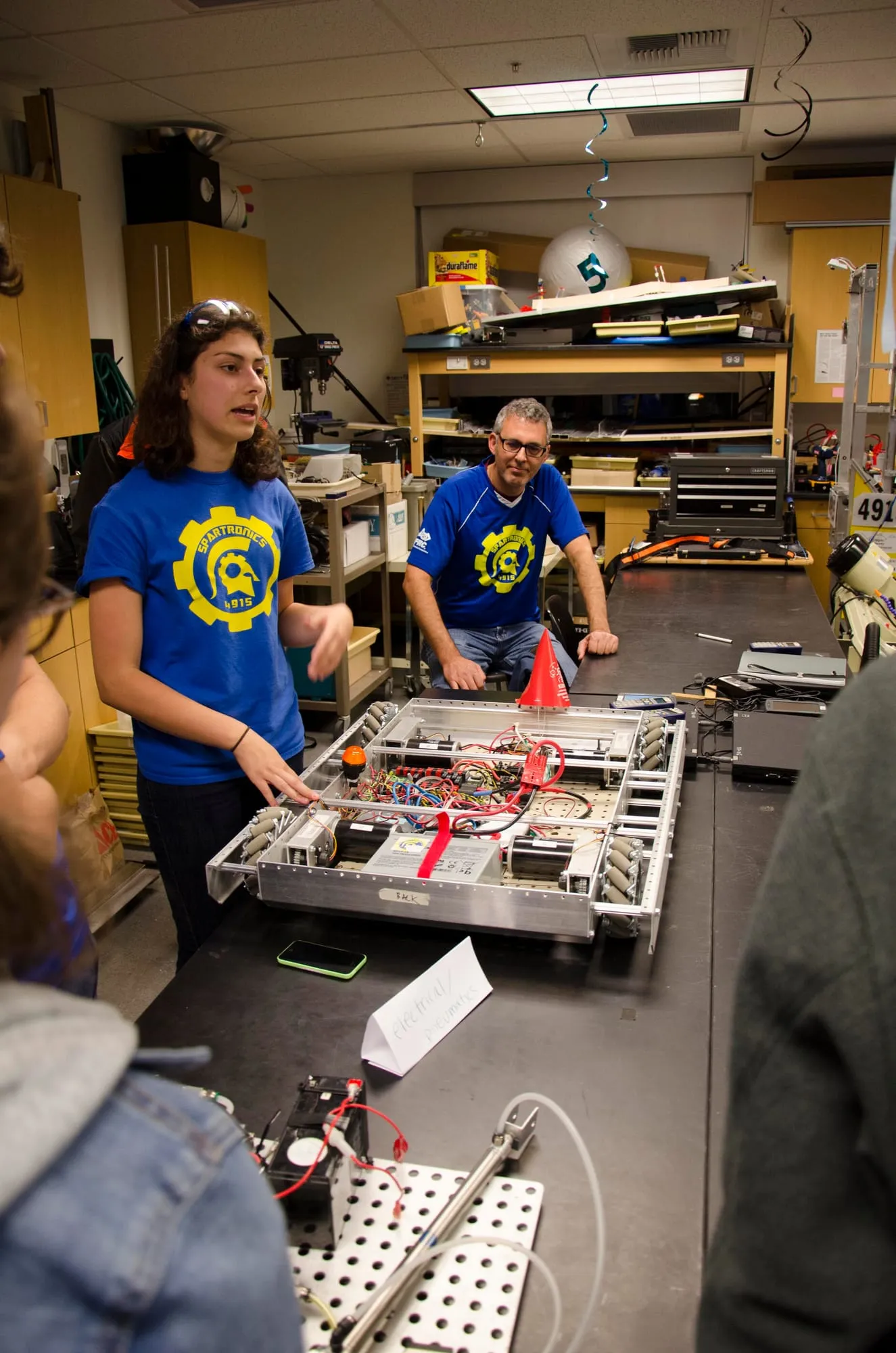 Spartronics students working on a robot in the shop
