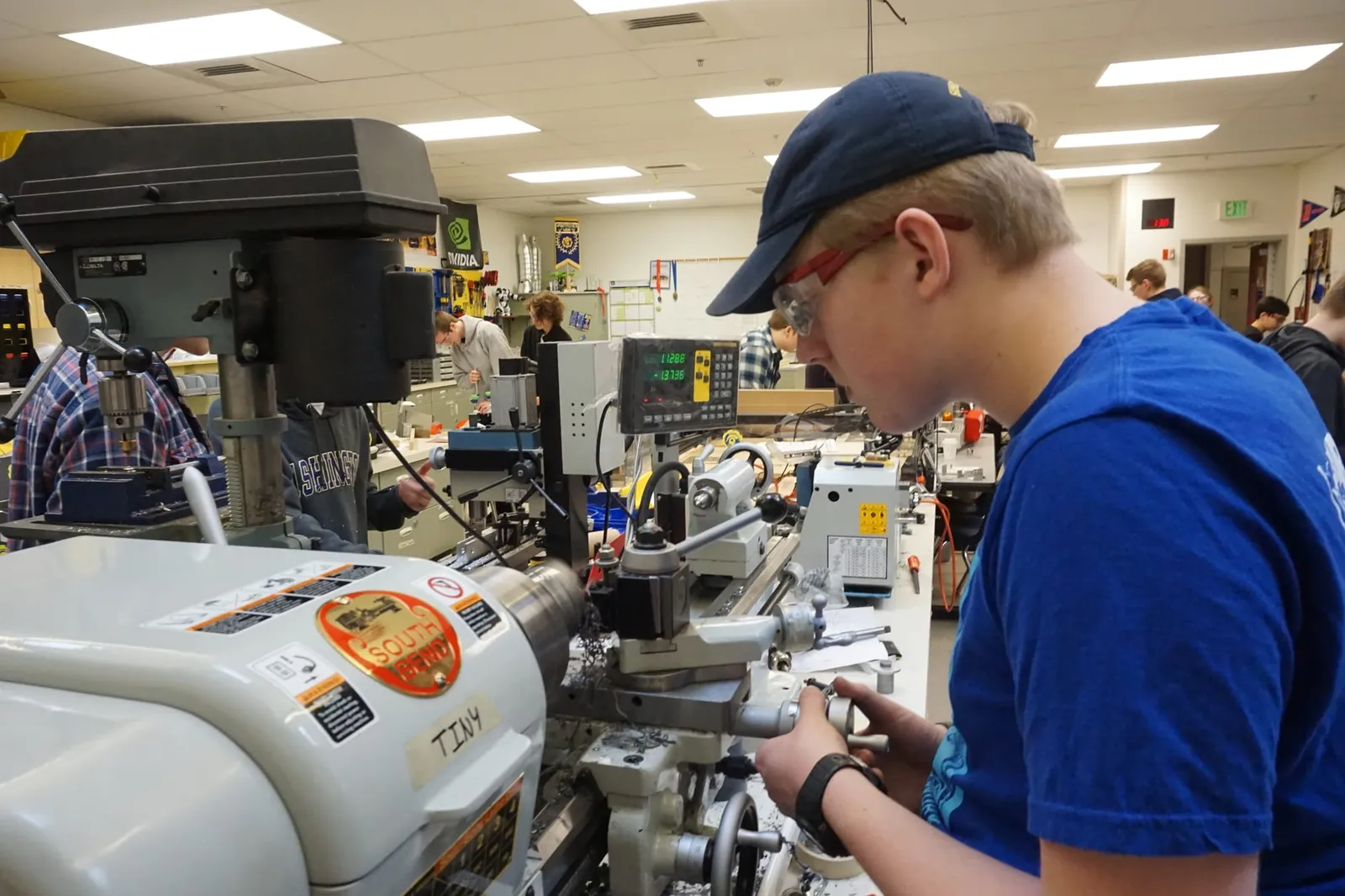 A Spartronics student machining a part on a lathe