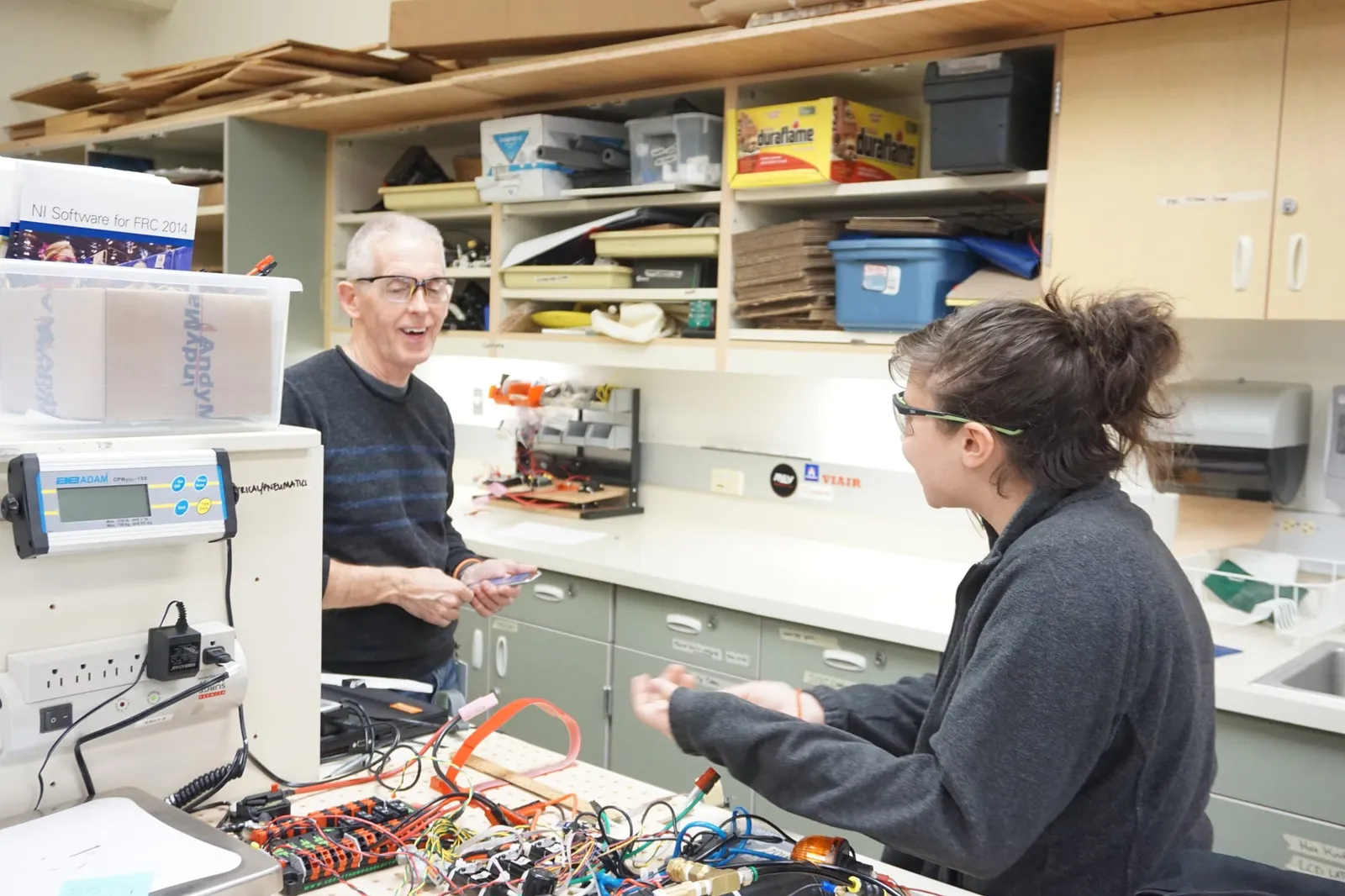 Spartronics mentor and student meet to talk about the robot