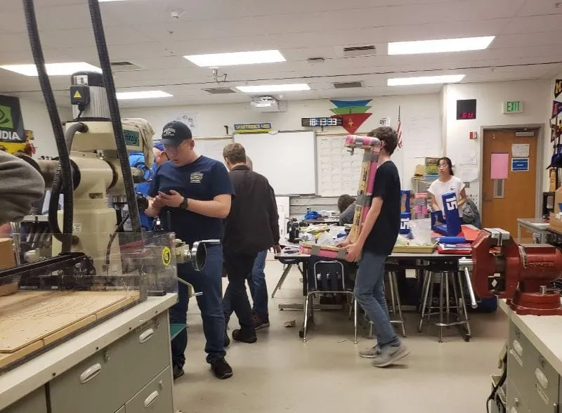 Spartronics students assembling the robot