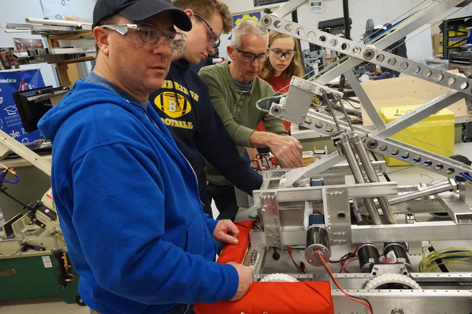 Spartronics students and mentors work on the robot